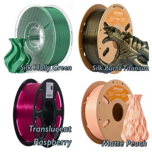 May include: Four spools of filament for 3D printing.  The spools are labeled "Silk Holly Green", "Silk Burnt Titanium", "Translucent Raspberry", and "Matte Peach".