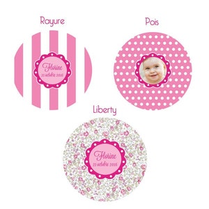 May include: Three pink and white patterned circles with the text "Rayure", "Pois", and "Liberty" above each circle. Each circle has a pink and white design with a pink circle in the center. The center circle has the text "Florine 21 octobre 2016" in white. The "Pois" circle has a photo of a baby girl in the center.