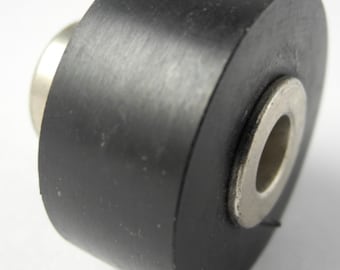 May include: A black rubber roller with a metal center, used for furniture or other objects.