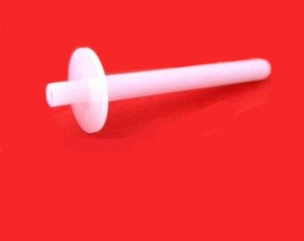 May include: White plastic sewing machine bobbin winder with a round base and a long, thin shaft.