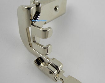 May include: Silver sewing machine foot with a pointed tip and a screw adjustment. The foot is designed for sewing straight lines and has a guide to help keep the fabric straight.