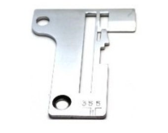 May include: A silver sewing machine needle plate with a slot for the needle and a hole for the bobbin. The plate has the number 355 printed on it.