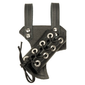 May include: Black leather sword scabbard with a lace-up design and silver metal eyelets. The scabbard has two straps for attaching to a belt.