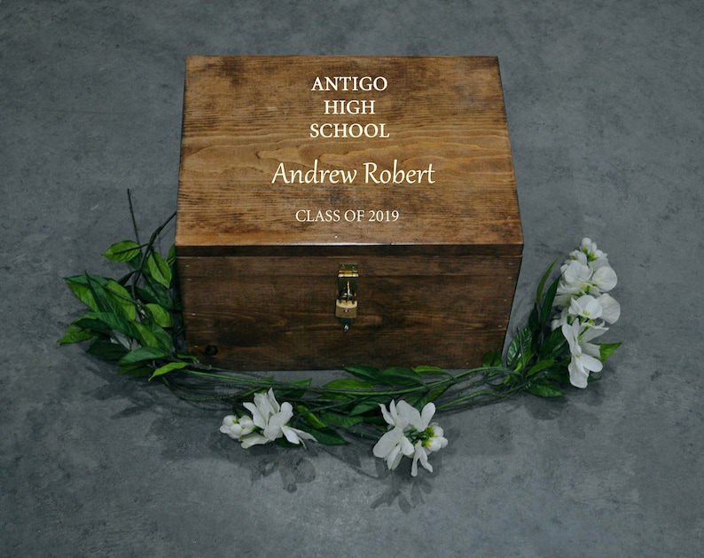 May include: A wooden box with a hinged lid and a lock. The box is engraved with the text "Antigo High School", "Andrew Robert", and "Class of 2019".