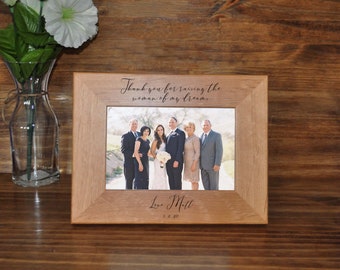 May include: A wooden picture frame with a photo of a family of six. The frame is engraved with the text "Thank you for raising the woman of my dreams. Love Matt 9.8.20".