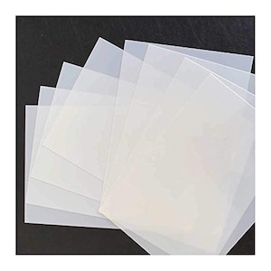 May include: A stack of six clear plastic sheets, likely for crafting or art projects.