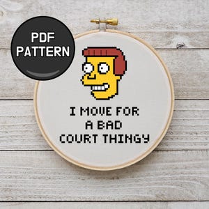 May include: A cross-stitch embroidery hoop featuring a pixelated cartoon character with yellow skin and red hair. The text "I MOVE FOR A BAD COURT THINGY" is stitched below the character. A black circle with "PDF PATTERN" is in the upper left.