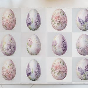 May include: Twelve pastel-colored Easter eggs with floral designs. The eggs are arranged in a grid pattern on a white background. The designs include roses, lavender, and other floral motifs.