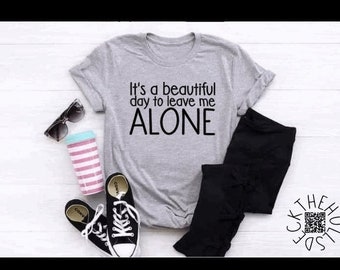 May include: A gray t-shirt with the text "It's a beautiful day to leave me ALONE" printed in black.