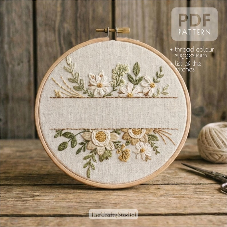 May include: A round embroidery hoop with a floral design. The design features white and gold flowers with green leaves, and the text "PDF PATTERN" is visible. The text "+ thread colour suggestions list of the stitches" is also visible.