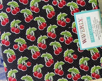 May include: A fat quarter of fabric featuring a repeating pattern of red cherries with green leaves on a black background with white polka dots. The fabric is labeled "Waverly Inspirations" and measures 18 x 21 inches.
