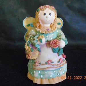 Angel Holding Basket of Flowers