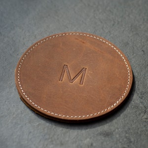 handcrafted leather coasters in a warm honey hue, perfect for protecting surfaces and adding a touch of personalized rustic elegance to your decor.