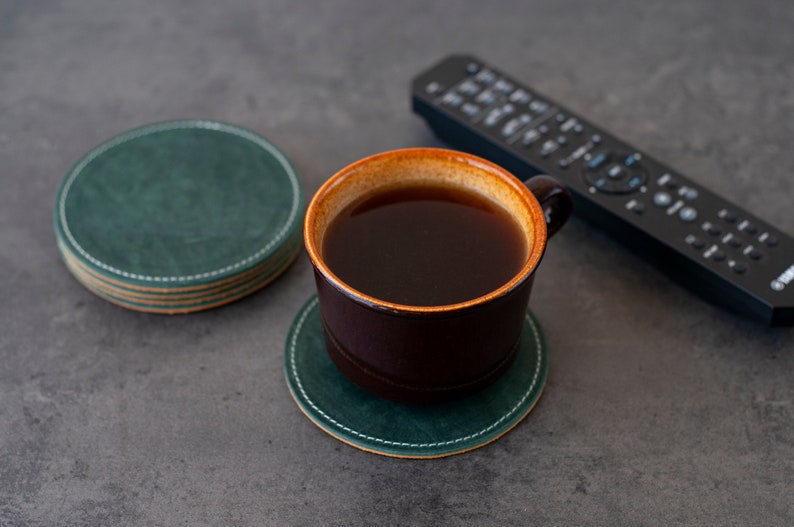 Bring a touch of nature indoors with this set of 4 handcrafted leather coasters in a vibrant emerald green.