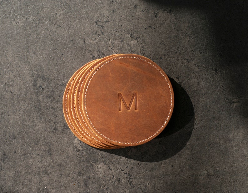 handcrafted leather coasters in a warm honey hue, perfect for protecting surfaces and adding a touch of personalized rustic elegance to your decor.