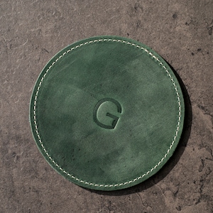 Bring a touch of nature indoors with this personalized handcrafted leather coasters in a vibrant emerald green.