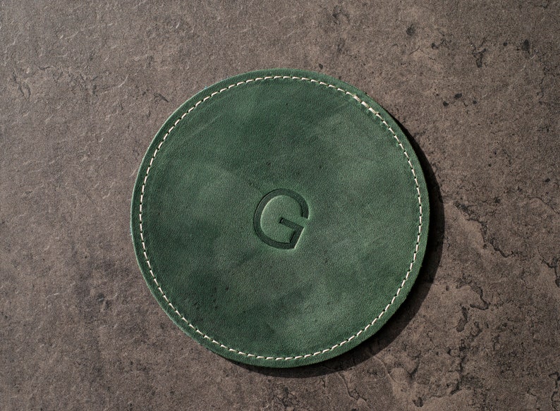 Bring a touch of nature indoors with this personalized handcrafted leather coasters in a vibrant emerald green.