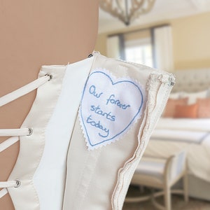 Custom handwriting embroidered on a wedding dress label. Personalised something blue for bride. Wedding memorial gift for bride from mother