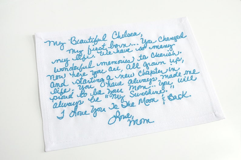May include: A white tea towel with blue embroidered text that reads "My beautiful Chelsea, my first born... You changed my life. We have so many wonderful memories to cherish. Now here you are, all grown up, and starting a new chapter in life. You have always made me proud to be your mom... You will always be my sunshine. I love you to the moon and back. Love, Mom."