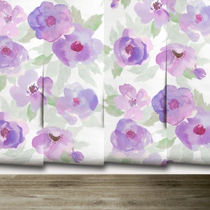 May include: A seamless pattern of watercolour purple flowers on a white background. The flowers are in various shades of purple and pink, with some having a more defined centre.