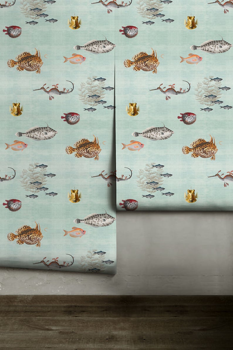 May include: A light blue wallpaper with a repeating pattern of sea creatures. The pattern includes seahorses, pufferfish, anglerfish, and small fish. The wallpaper has a subtle textured look.