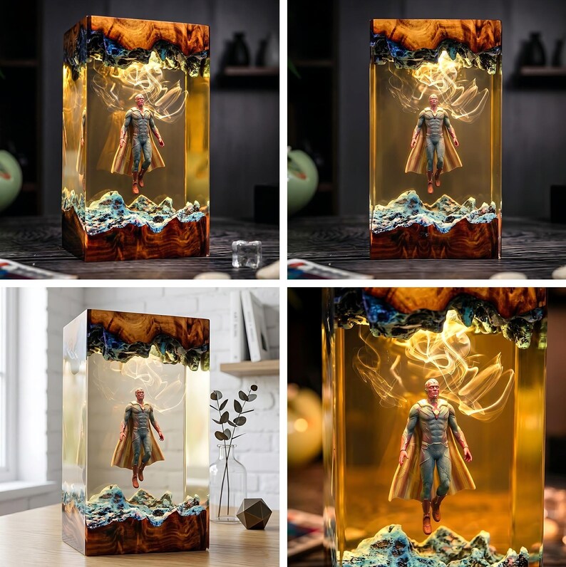 May include: A rectangular resin art piece featuring a superhero figure suspended within. The base and top have a wood-like appearance, with blue and white accents. The figure is wearing a blue and gold costume with a cape.