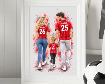 May include: A framed watercolor-style print depicting a family of three from behind. A person wears a red jersey labeled MUMMY 26 with blue jeans, another wears a red jersey labeled DADDY 25 with gray pants, and a child wears a red jersey labeled ABBIE 4.
