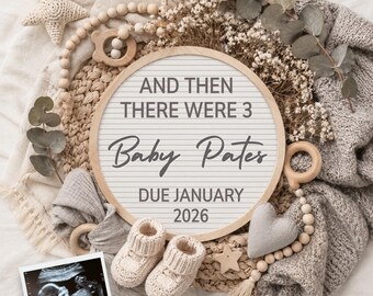 May include: A round letter board with the text AND THEN THERE WERE 3 Baby Pates DUE JANUARY 2026, surrounded by cream-colored knit baby booties, a star-shaped crochet toy, a heart-shaped pillow, wooden beads, dried flowers, and an ultrasound photo.