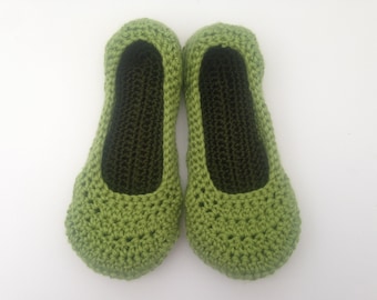 May include: A pair of green crocheted slippers. The slippers are made with a simple stitch pattern and have a rounded toe.