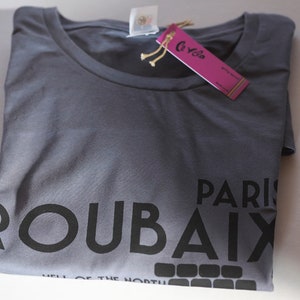 May include: A grey t-shirt with black text that reads "Roubaix" and "Paris" with the words "Hell of the North" underneath.