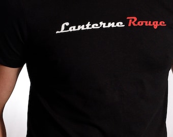 May include: Black t-shirt with white text that says "Lanterne Rouge" in a cursive font. The word "Rouge" is in red.