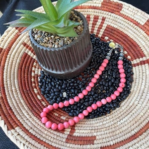 This Southwestern necklace features beautiful pink bamboo coral and sterling silver Navajo pearls