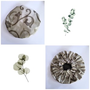May include: Two shower caps with a floral pattern. One is a light brown with a dark brown floral pattern. The other is a light brown with a darker brown floral pattern. Both caps are made of satin.