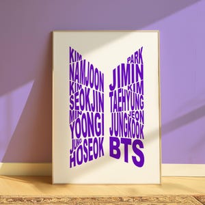 May include: A white poster with a purple BTS logo. The logo is made up of the names of the band members, including "Kim Namjoon", "Kim Seokjin", "Min Yoongi", "Jung Hoseok", "Park Jimin", "Kim Taehyung", and "Jeon Jungkook".