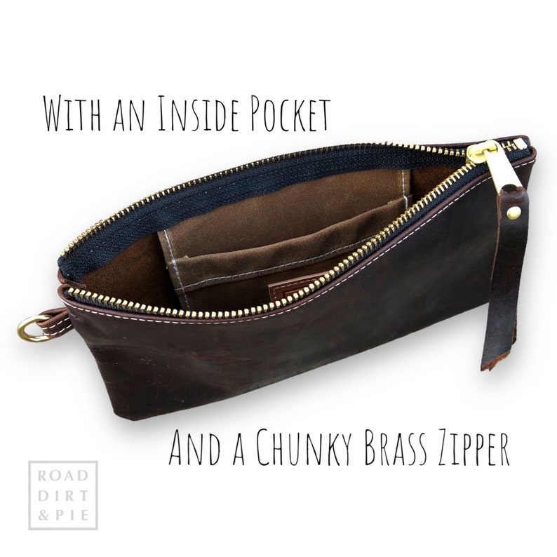 A brown leather zippered pouch with a white stitch detail. The pouch is open to reveal a small canvas interior pocket. The zipper is brass and has a chunky pull. The text 'WITH AN INSIDE POCKET' is above the pouch and the text 'AND A CHUNKY BRASS ZIPPER' is below the pouch.