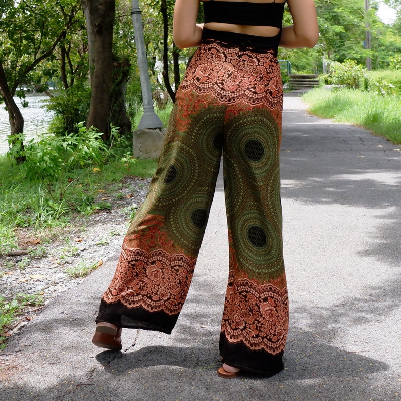 May include: Green and orange printed wide-leg pants with a black waistband and a floral pattern.