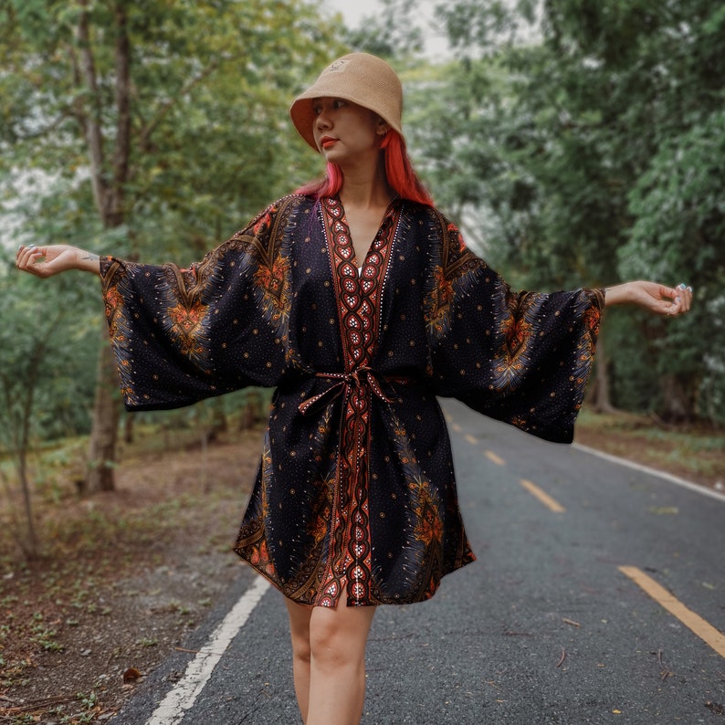 Boho woman wearing a short kimono with bohemian patterns