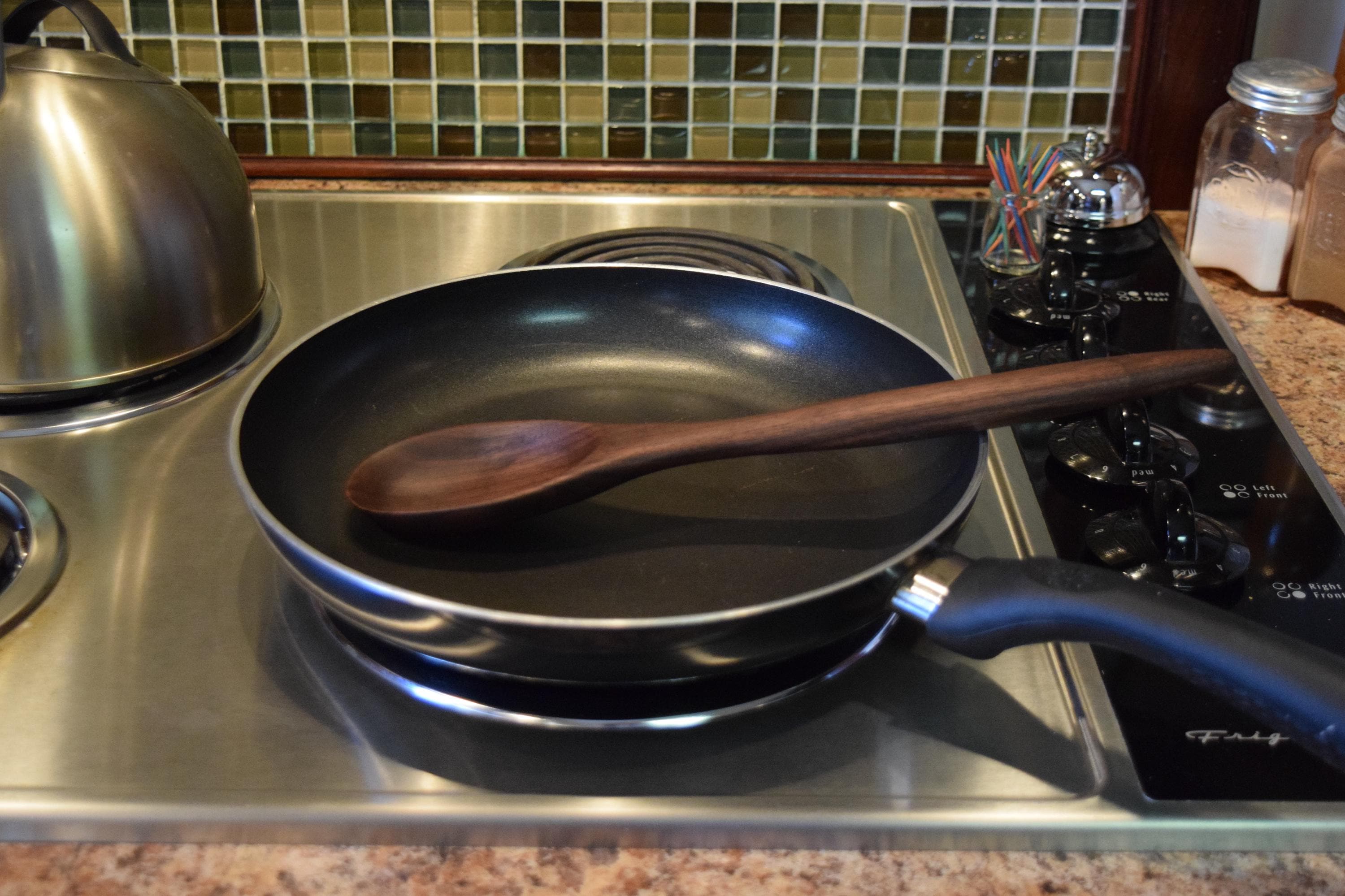 Handmade walnut spoon about 13 inches long, 2 1/2 inches or more wide.
