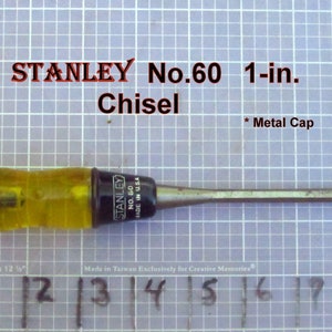 May include: A Stanley No. 60 1-in. chisel with a yellow and black handle. The chisel is made in the USA and has a metal cap.