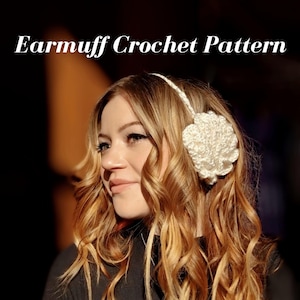 May include: White crocheted earmuffs with a flower design. The earmuffs are worn by a person with long, wavy, light brown hair.