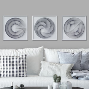 May include: Three white framed wall art pieces with navy blue string art designs. Each piece features a different geometric pattern.