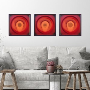 May include: Three framed abstract art prints with red, orange, and yellow gradients. Each print features a geometric design in the center.