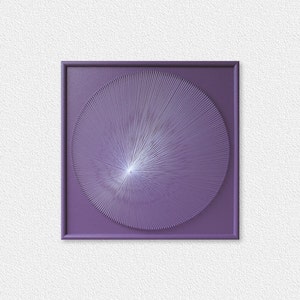 May include: A framed artwork with a purple background and a white circular design in the centre. The design is made up of thin lines radiating outwards from the centre.
