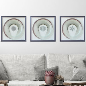 May include: Three framed string art pieces with geometric designs in shades of gray and white. The frames are a dark gray with a thin red border.