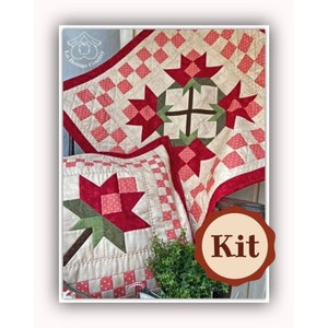 Può includere: Un set di biancheria da letto trapuntato con un motivo floreale. Il set include una trapunta e un cuscino, entrambi con sfondo crema e accenti floreali rossi e verdi. La trapunta ha un bordo rosso e un design patchwork. L'immagine include anche il testo "Kit".