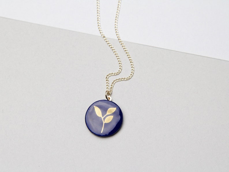 Blue porcelain pendant with gold leaf.