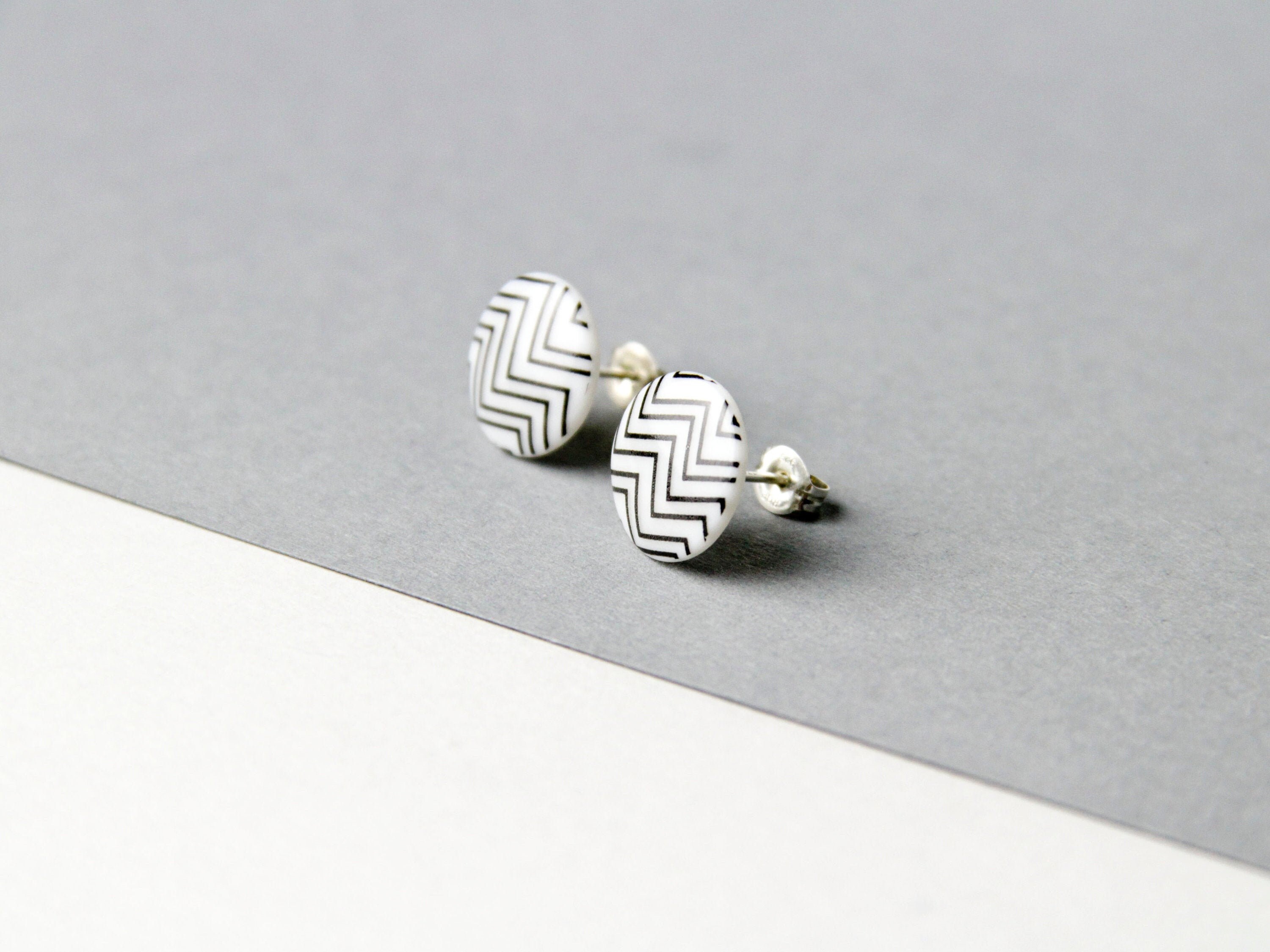 Stud earrings, snow-white porcelain, black zigzag