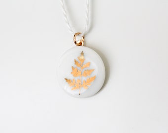 Snow-white porcelain, golden fern.