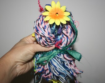 Hand spun Art yarn 141. "Summer Time" Core spun textured art yarn with coils and spirals and curly locks with gorgeous silk flowers.
