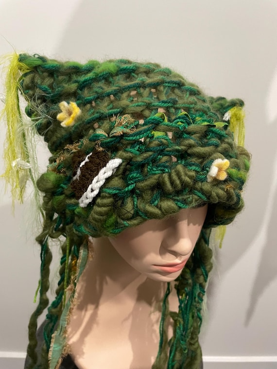 Tree Fungi hat! Deep in the forest next to the river. Freeform knitted woodland forest hat with crocheted fungi, and cascading art yarns.